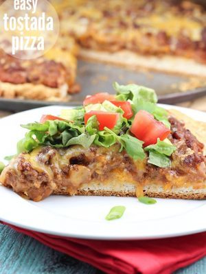 Easy Tostada Pizza is a fun cross between a taco, pizza and a tostada! Yummy, quick & easy dinner for any night of the week!