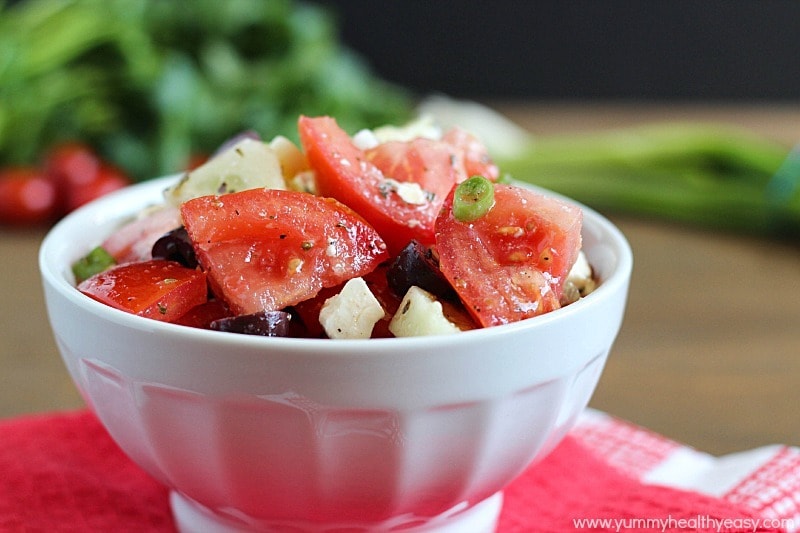 Greek Tomato Salad | easy salad made with tomatoes, cucumbers, olives, green onions & feta cheese and tossed with a homemade dressing. Light and delicious! Greek Tomato Salad | easy salad made with tomatoes, cucumbers, olives, green onions & feta cheese and tossed with a homemade dressing. Light and delicious!