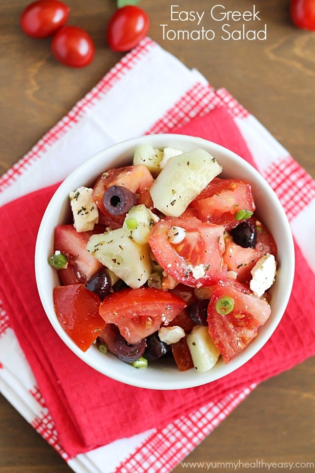 Greek Tomato Salad | easy salad made with tomatoes, cucumbers, olives, green onions & feta cheese and tossed with a homemade dressing. Light and delicious! Greek Tomato Salad | easy salad made with tomatoes, cucumbers, olives, green onions & feta cheese and tossed with a homemade dressing. Light and delicious!