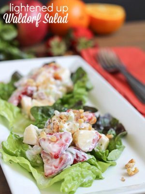 Lightened Waldorf Salad on lettuce leaves on a white plate.