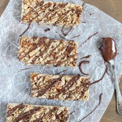 Top view of Easy No-Bake Granola Bars with oats, almonds and coconut with a delicious chocolate & Nutella drizzle on top + 43 Healthy Snack Ideas