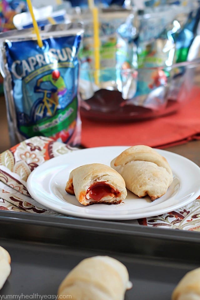Simple & delicious Pizza Rolls made from ready-made pizza dough, mozzarella sticks, pizza sauce and pepperoni all rolled together in a fun little bite and served with a refreshing Capri Sun! #ad