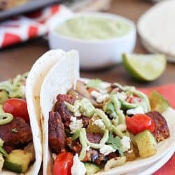Roasted Vegetable & Black Bean Tacos served with Avocado Crema. Healthy, meatless and delicious! #ad #morningstarfarms