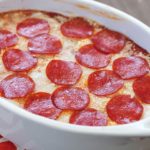 The most unbelievable pizza dip! A layer of herbed cream cheese, homemade sauce, cheese and then topped with pepperoni. AMAZING!
