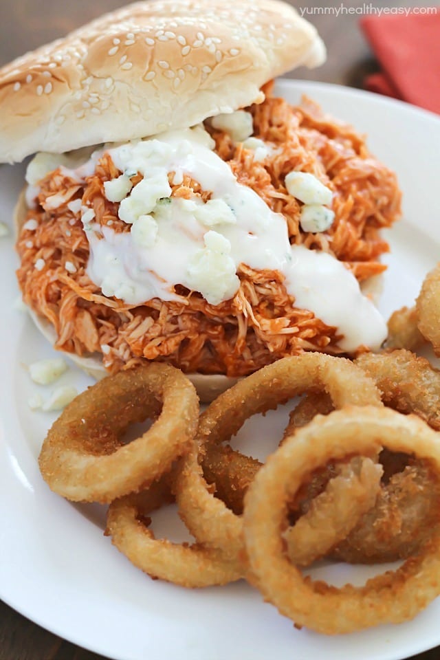 You will love these 3-ingredient Crock Pot Buffalo Chicken Sandwiches! Shredded buffalo chicken inside buns and smothered with blue cheese and hot sauce. So easy and absolutely delicious!