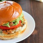 The juiciest, most delicious, guacamole chicken burgers! Super simple to make - serve on buns with a layer of guacamole on the top. Amazing!