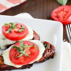 Easy Balsamic Chicken recipe with a caprese twist! Chicken breasts are cooked until tender in a flavorful balsamic sauce then topped with mozzarella, basil & tomato. Low carb and gluten free!