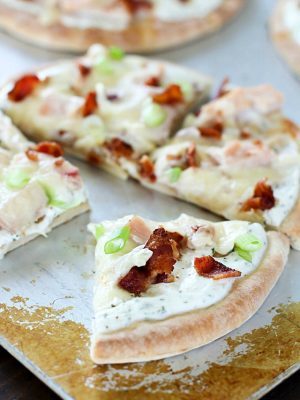 Bacon Ranch Chicken Pita Pizza on a cookie sheet, sliced up!
