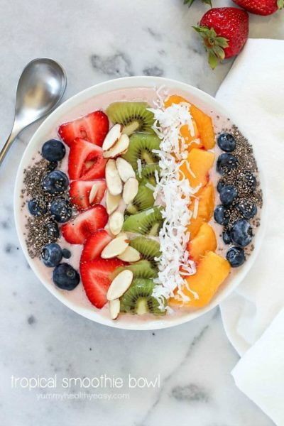 This Tropical Smoothie Bowl Recipe is the perfect breakfast or snack! It's dairy-free, gluten-free, full of protein and fresh fruit and totally delicious. Satisfying and easy to make, too! #SilkCashew #ad