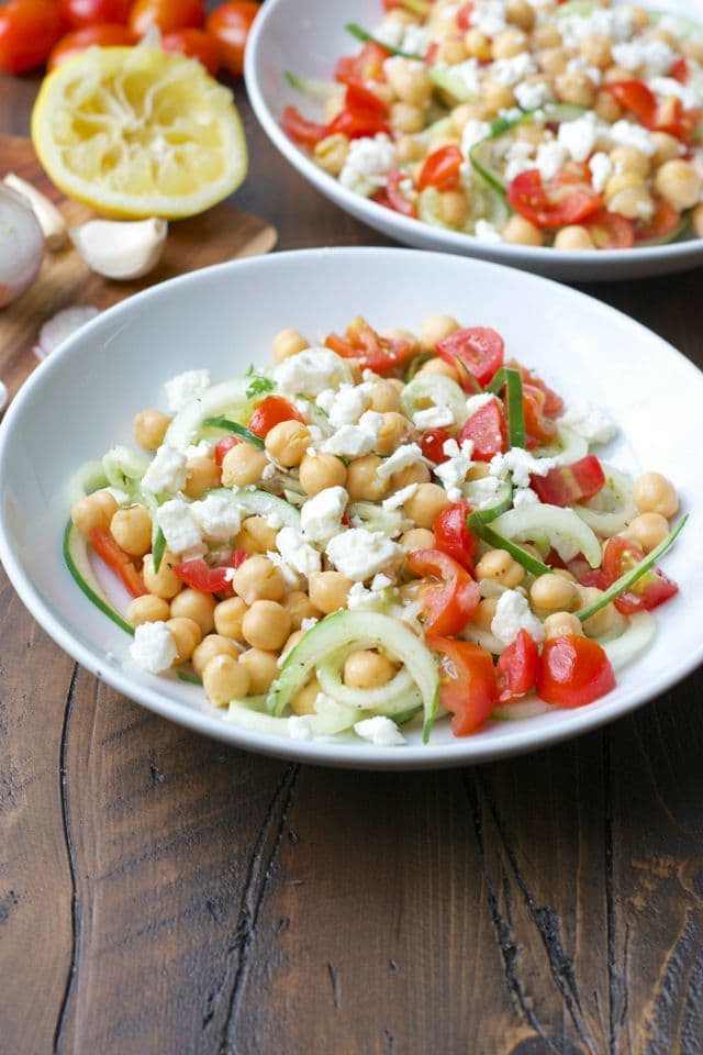 This Cucumber Chickpea Salad is packed with spiralized cucumbers, cherry tomatoes, chickpeas, feta and tossed in a simple lemon vinaigrette for a light and fresh meal.