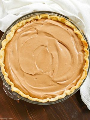 An incredibly Easy Chocolate Pie recipe that my Mom makes every Thanksgiving as a tradition. This is so simple and uses no pudding. This is a family favorite chocolate pie! A must for your holiday dessert table!