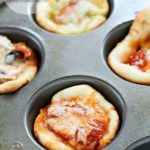 Dinner doesn't get easier than this: Easy Muffin Tin Mini Pizzas! They're ready in about 20 minutes and are customizable to what you like. Kids love these and love to help make them!