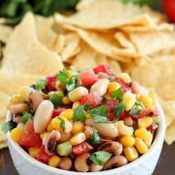 A white bowl is filled with colorful Cowboy Caviar - 43 Healthy Snack Ideas