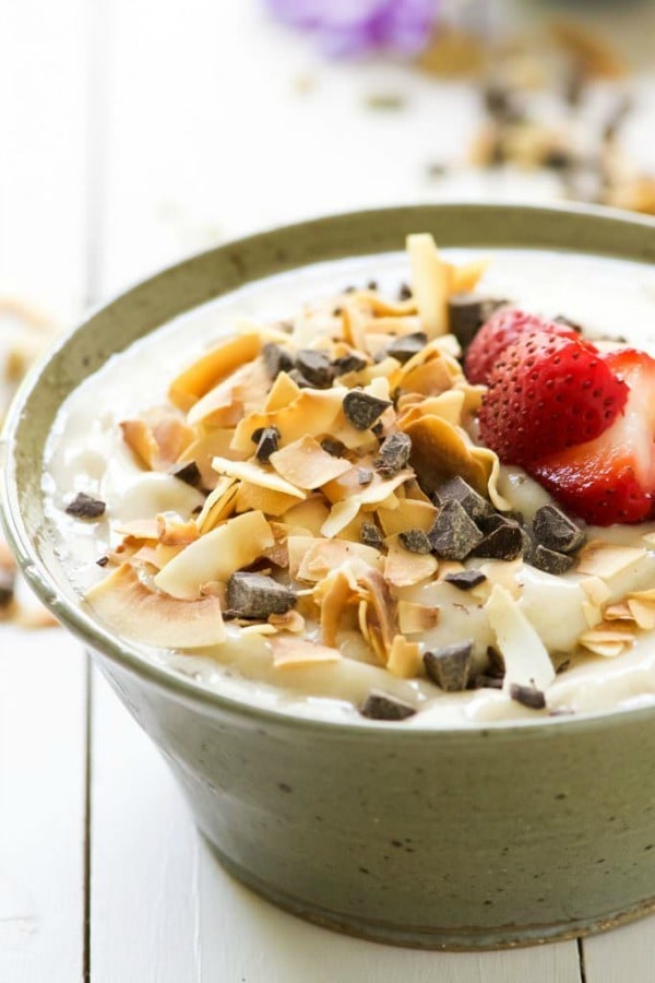 Dark Chocolate and Toasted Coconut Smoothie Bowl is a nutritious and fun twist on a smoothie! Filled with tropical flavors of banana and coconut then topped with dark chocolate, fruit, granola and chia seeds!
