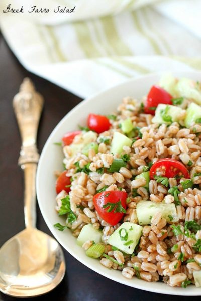 Farro Salad full of tender farro, tomatoes, cucumber, green onions, parsley, and tossed in an olive oil & lemon dressing. Super easy and delicious side dish! With a delicious mix of flavors and textures - I will be making this farro salad again and again and again. :)