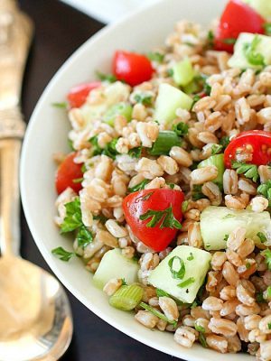 Farro Salad full of tender farro, tomatoes, cucumber, green onions, parsley, and tossed in an olive oil & lemon dressing. Super easy and delicious side dish! With a delicious mix of flavors and textures - I will be making this farro salad again and again and again. :)