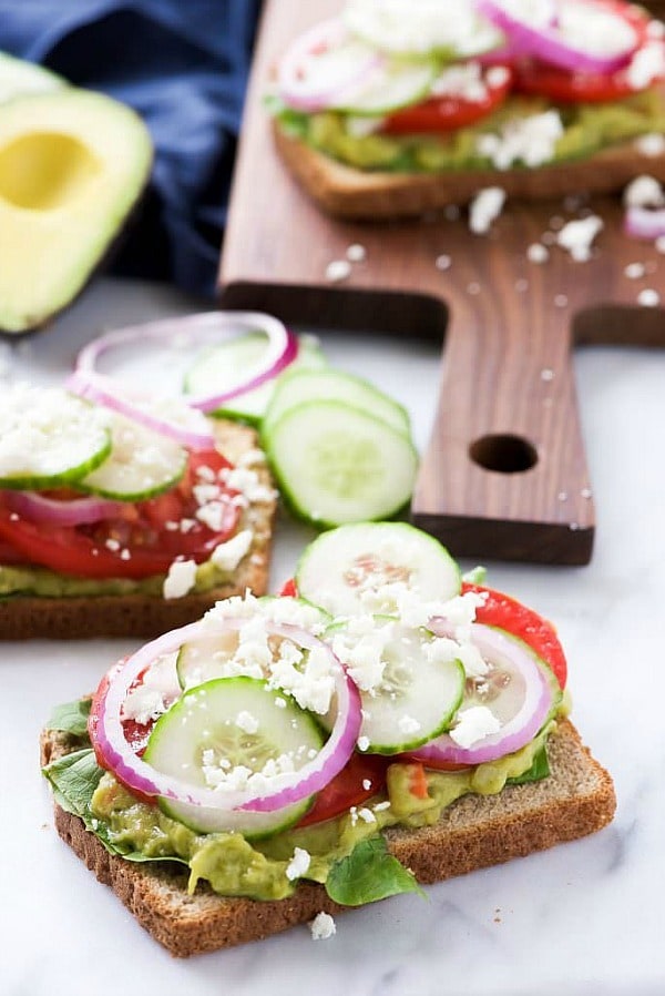 Mediterranean Avocado Toast is a spin off of my favorite veggie filled sandwich from Panera that satisfies both vegetarians and meat-lovers! A super quick and fresh, colorful sandwich – garden veggie filled guacamole, crispy cucumbers, red onions, juicy tomatoes and salty feta!