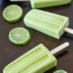 Creamy Avocado Coconut Popsicles - every bite is a tropical getaway! Who would have thought that avocado in a popsicle would be so delicious? You get a little coconut, lime and avocado in every bite of these popsicles! AD