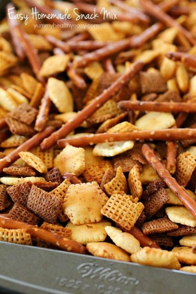 This Homemade Snack Mix Recipe is so easy to make and tastes delicious! Cereal, crackers and pretzels are tossed with a little butter and seasonings, then baked. Perfect to serve at a party or to munch on when you're watching the game. :)