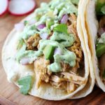 Pork Verde Tacos cooked in the crock pot and served with a drizzle of amazing jalapeño sauce. You will love the flavor in these pork tacos and love how easy they are to make! AD