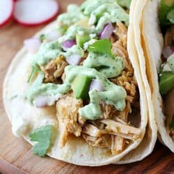 Pork Verde Tacos cooked in the crock pot and served with a drizzle of amazing jalapeño sauce. You will love the flavor in these pork tacos and love how easy they are to make! AD
