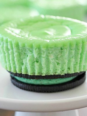 Skinny Mini Mint Cheesecakes with an Oreo crust! This lighter mint cheesecake recipe is super easy to make and you only need a few ingredients to whip up a batch. These cute cheesecakes have less calories than a regular cheesecake plus built-in portion control with the muffin size!