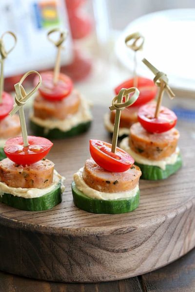 Low Carb Sausage Cucumber Bites skewered with toothpicks on top of a cutting board.