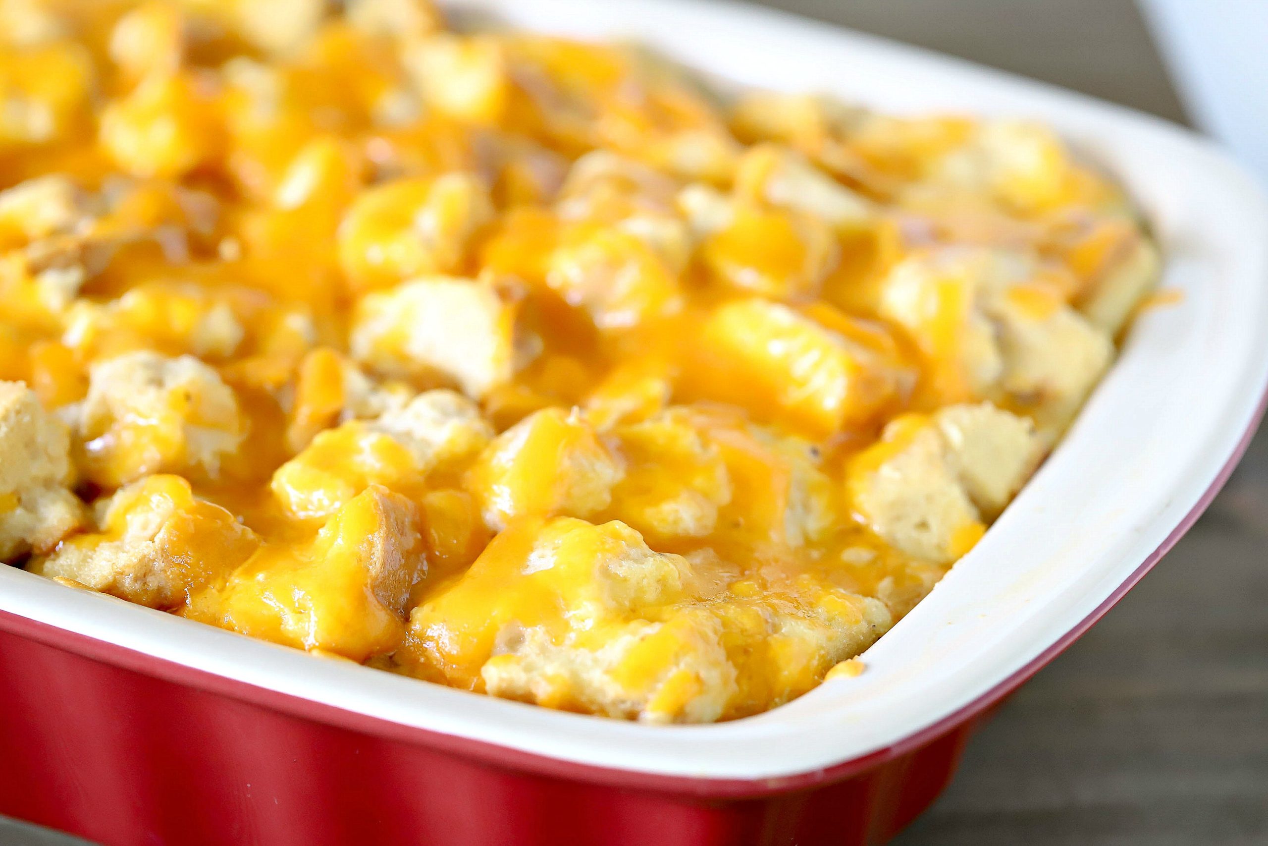 cheesy strata in a red casserole dish