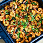 A pile of air fryer shrimp on a white plate.
