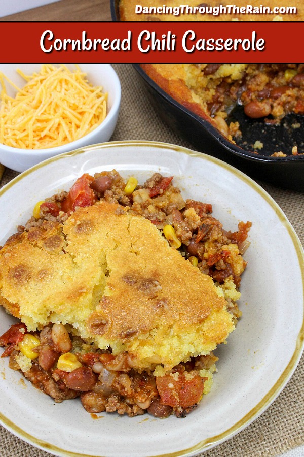 White plate with chili topped with cooked cornbread.