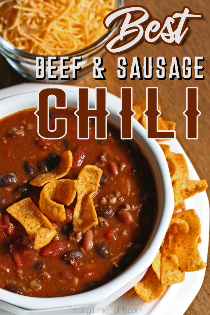 White bowl with beef and sausage chili, topped with Fritos.