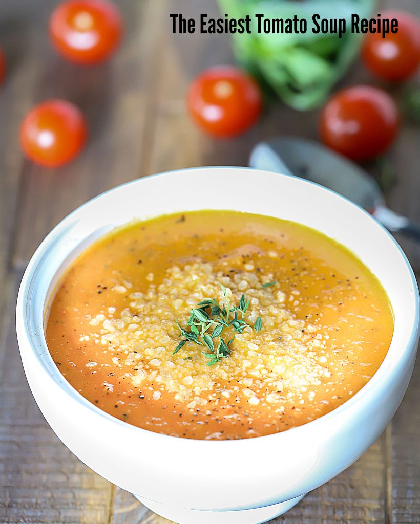 Bowl of soup topped with herbs.