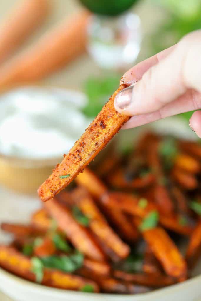 A slice of carrot above a plate.