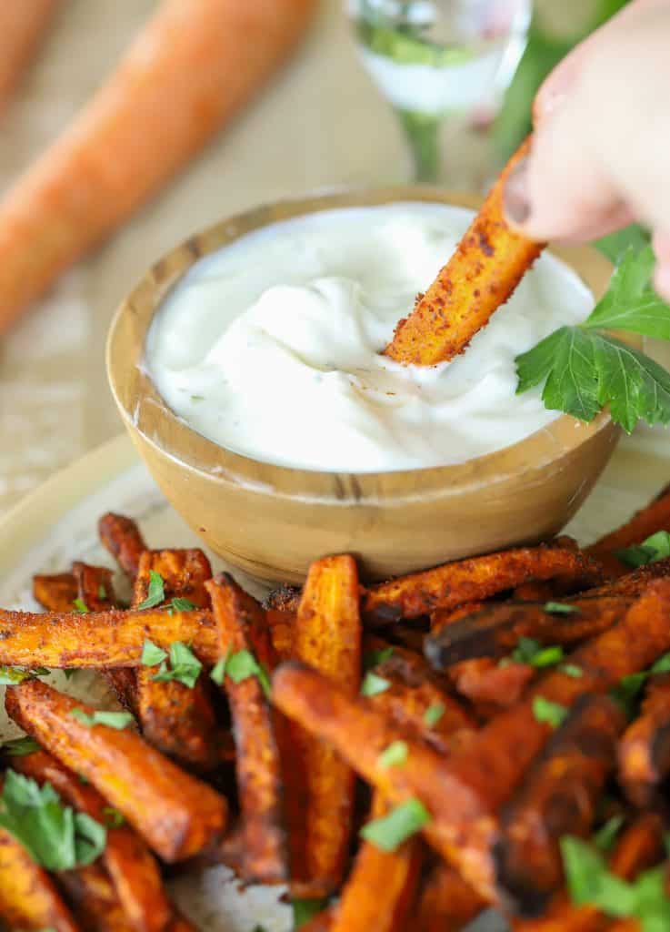 Carrot Fry being dipped in a side sauce.